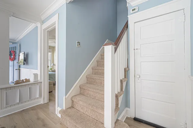 a view of a hallway with wooden floor and entryway