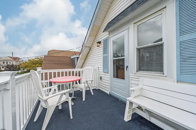 a view of a chairs with barbeque grill and wooden fence