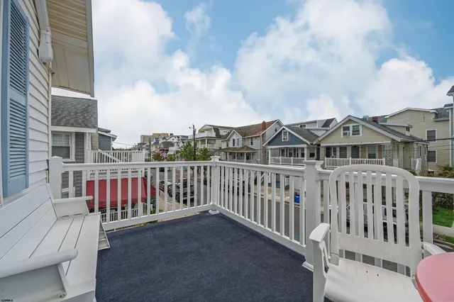 a view of a roof deck with chair and wooden floor