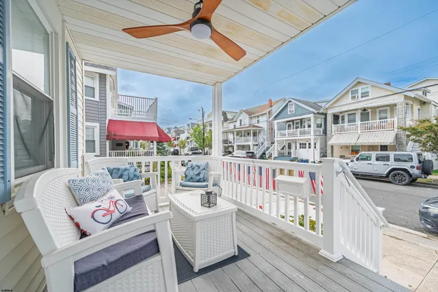 a front view of a house with outdoor seating