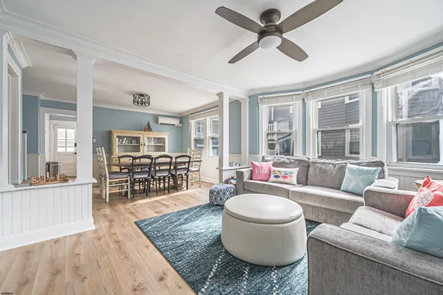 a living room with furniture and a wooden floor