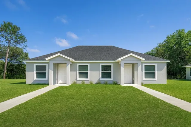 a front view of house with yard and green space