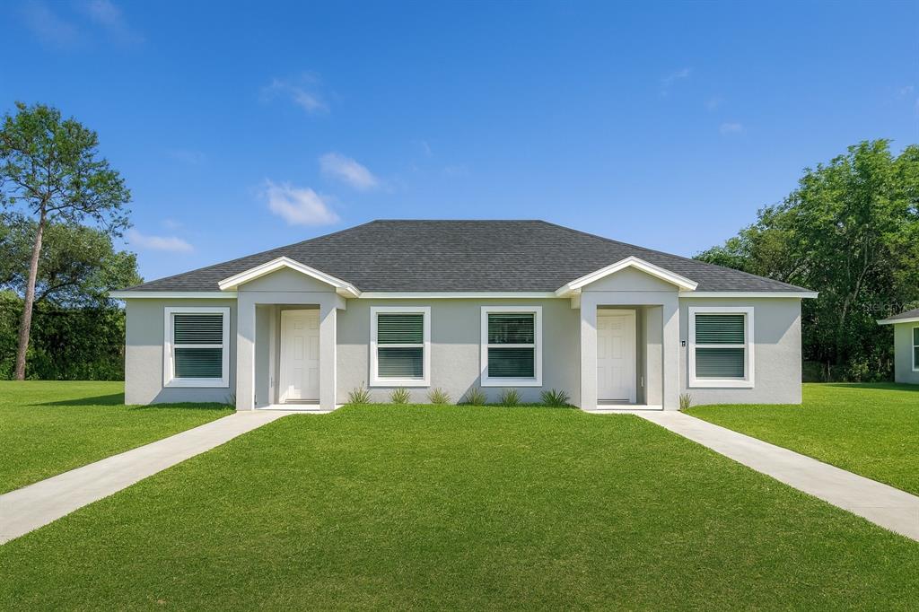 827 Hickory Avenue Inverness, FL 34452 - Photo 1 of 9 a front view of house with yard and green space