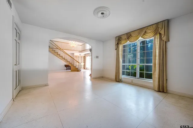 a view of a house with a yard balcony and sitting area