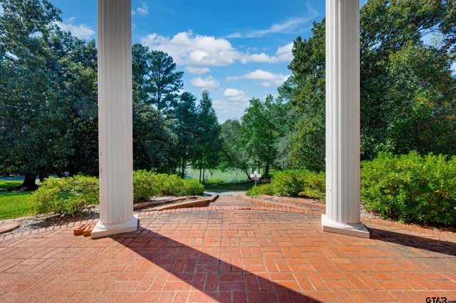 a view of a house with backyard and sitting area