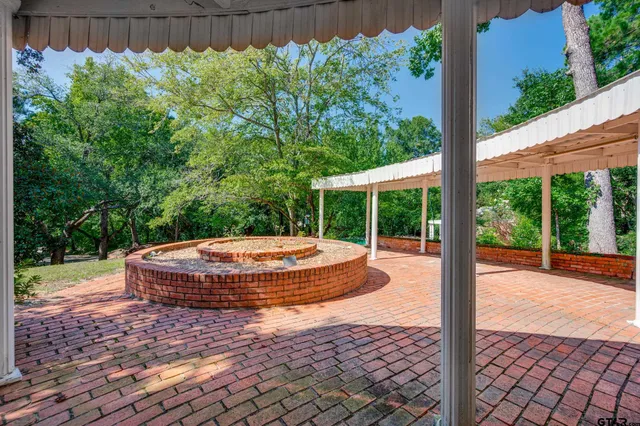 a front view of a house with yard and green space