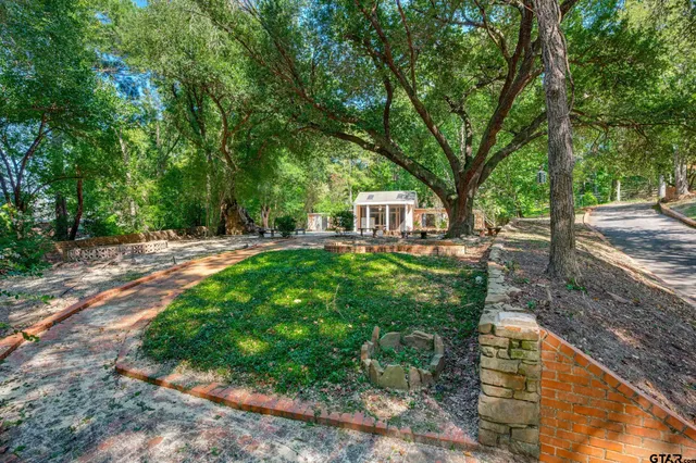 a front view of a house with a yard and table and chairs