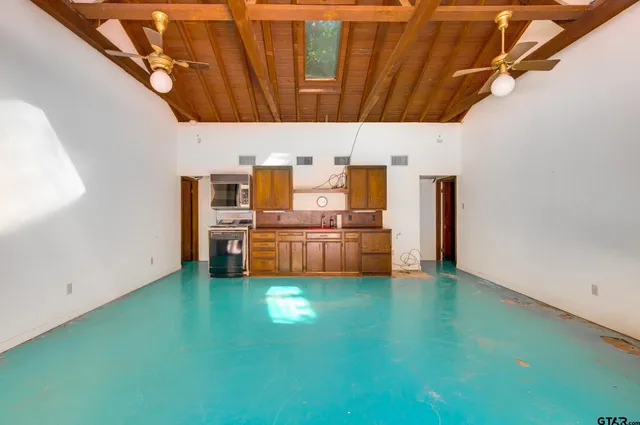 a view of a yard with plants and trees