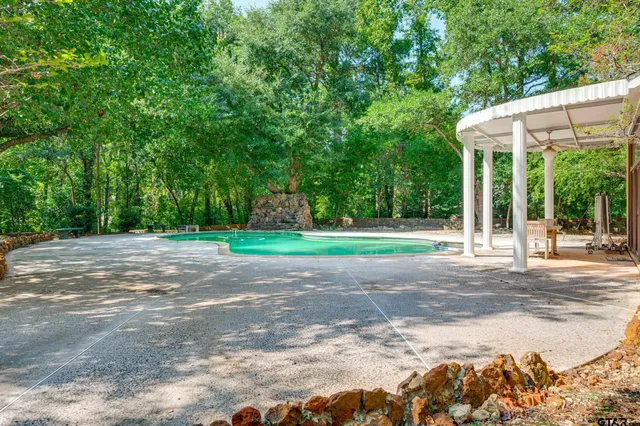 a view of a house with backyard and sitting area