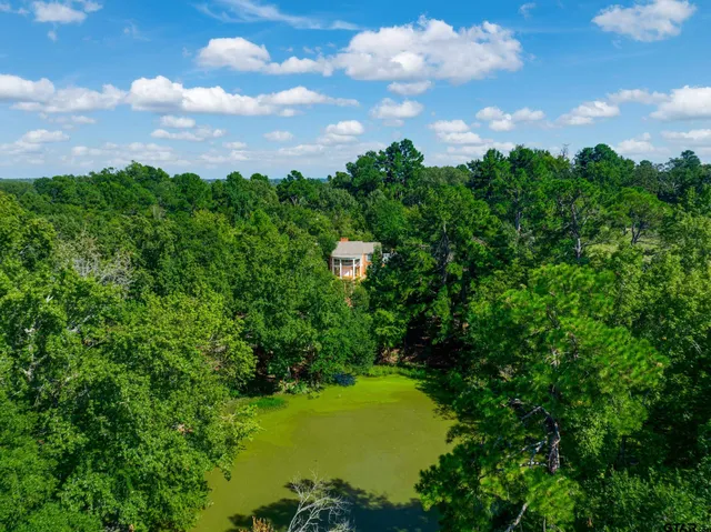a view of a patio with a table and chairs under an umbrella