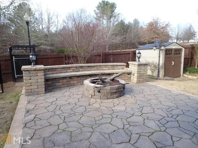 a view of backyard with tub and door