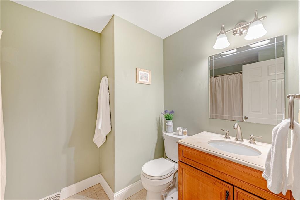 162 Hermitage Circle Ligonier, PA 15658 - Photo 28 of 38 a bathroom with a granite countertop sink toilet and a mirror