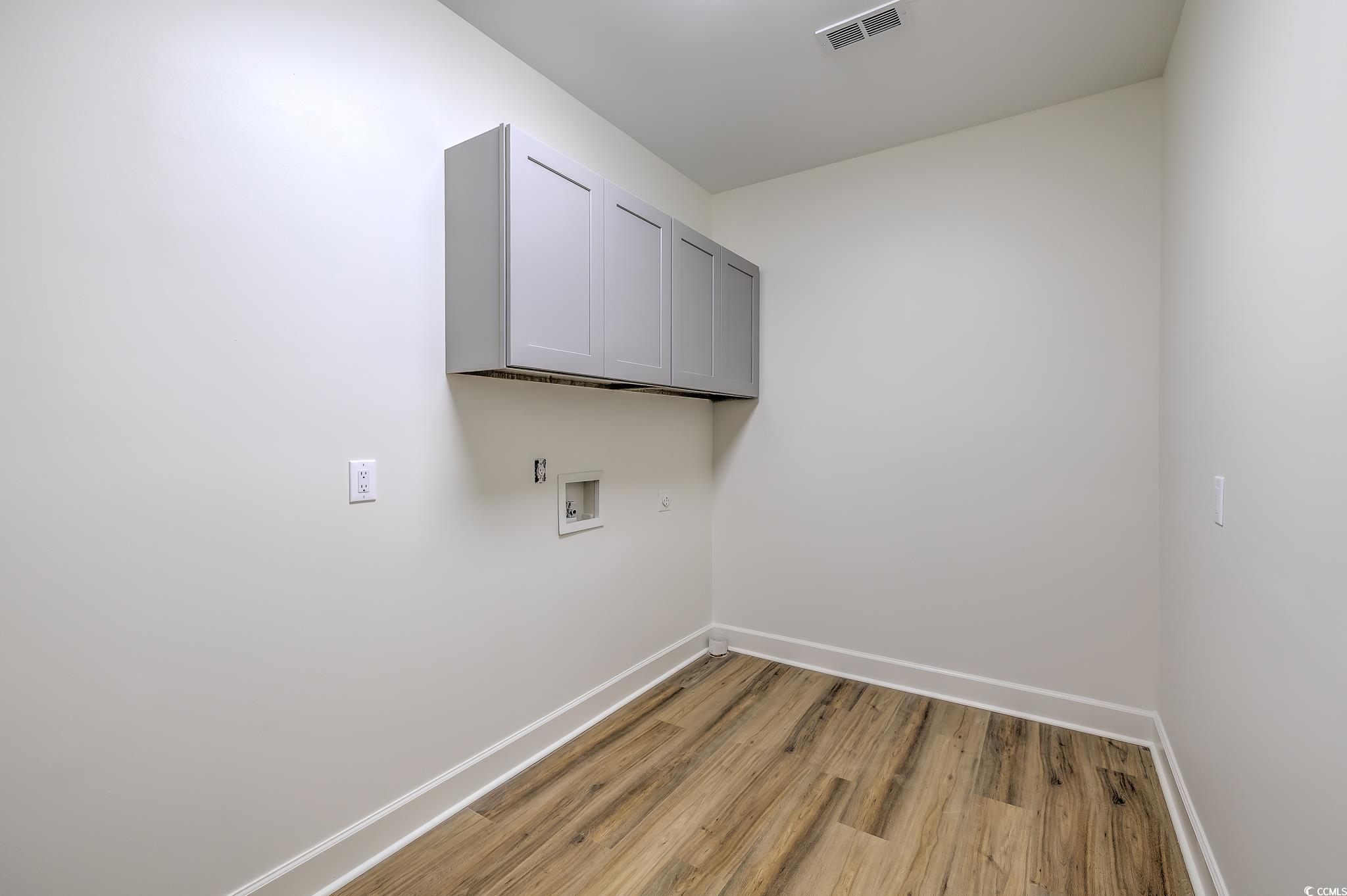 4000 Bayfield Loop Murrells Inlet, SC 29576 - Photo 23 of 33 Laundry area with cabinet space, hookup for a washing machine, and light wood-style floors