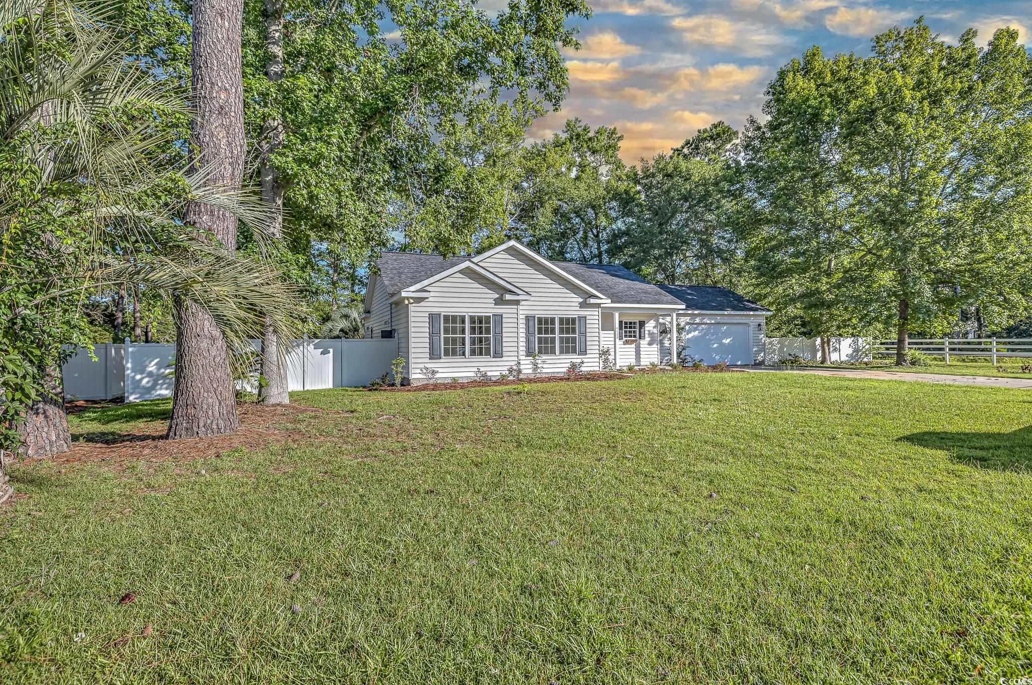 4000 Bayfield Loop Murrells Inlet, SC 29576 - Photo 3 of 33 Ranch-style home with a garage, a fenced backyard, and driveway