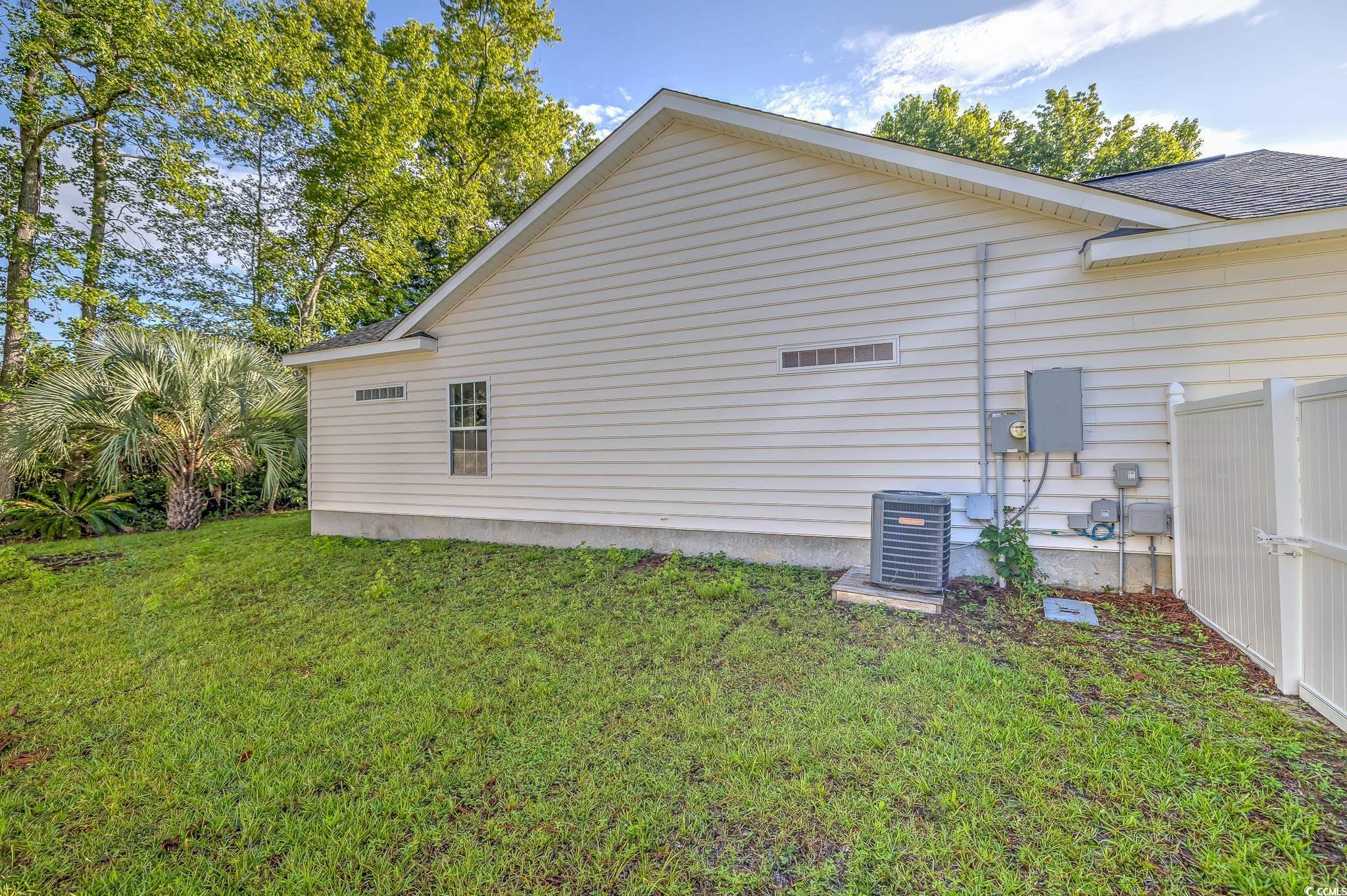 4000 Bayfield Loop Murrells Inlet, SC 29576 - Photo 8 of 33 View of side of home with a central AC unit and roof with shingles