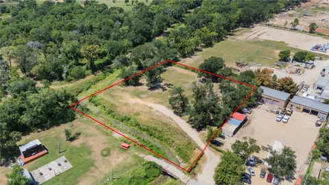 an aerial view of a house a yard and mountain