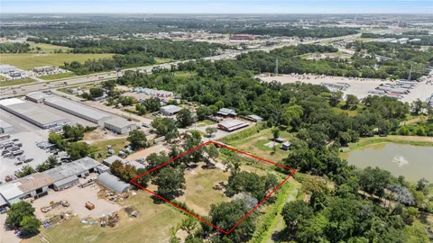 an aerial view of lake and residential houses with outdoor space