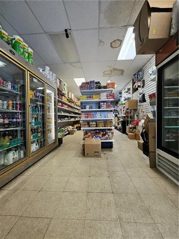 a living room with lots of furniture and a book shelf