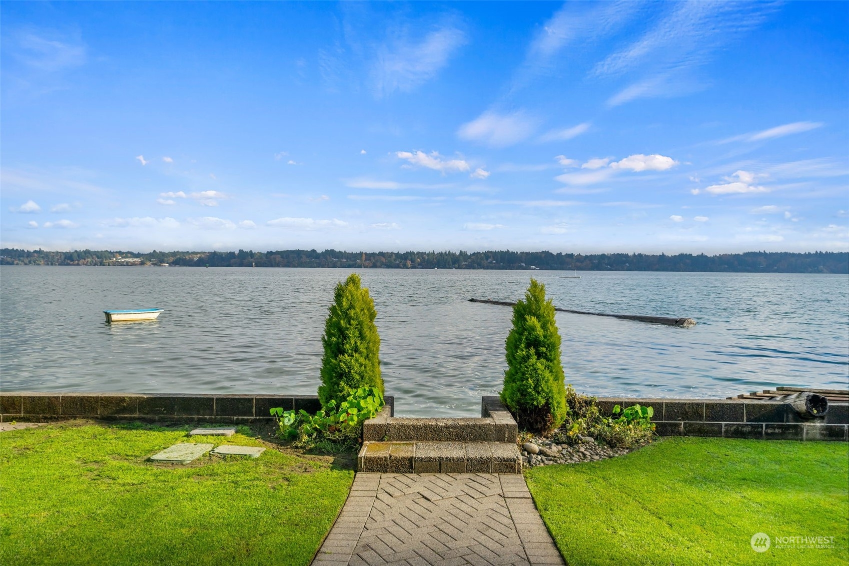 a view of a house with a garden and lake view