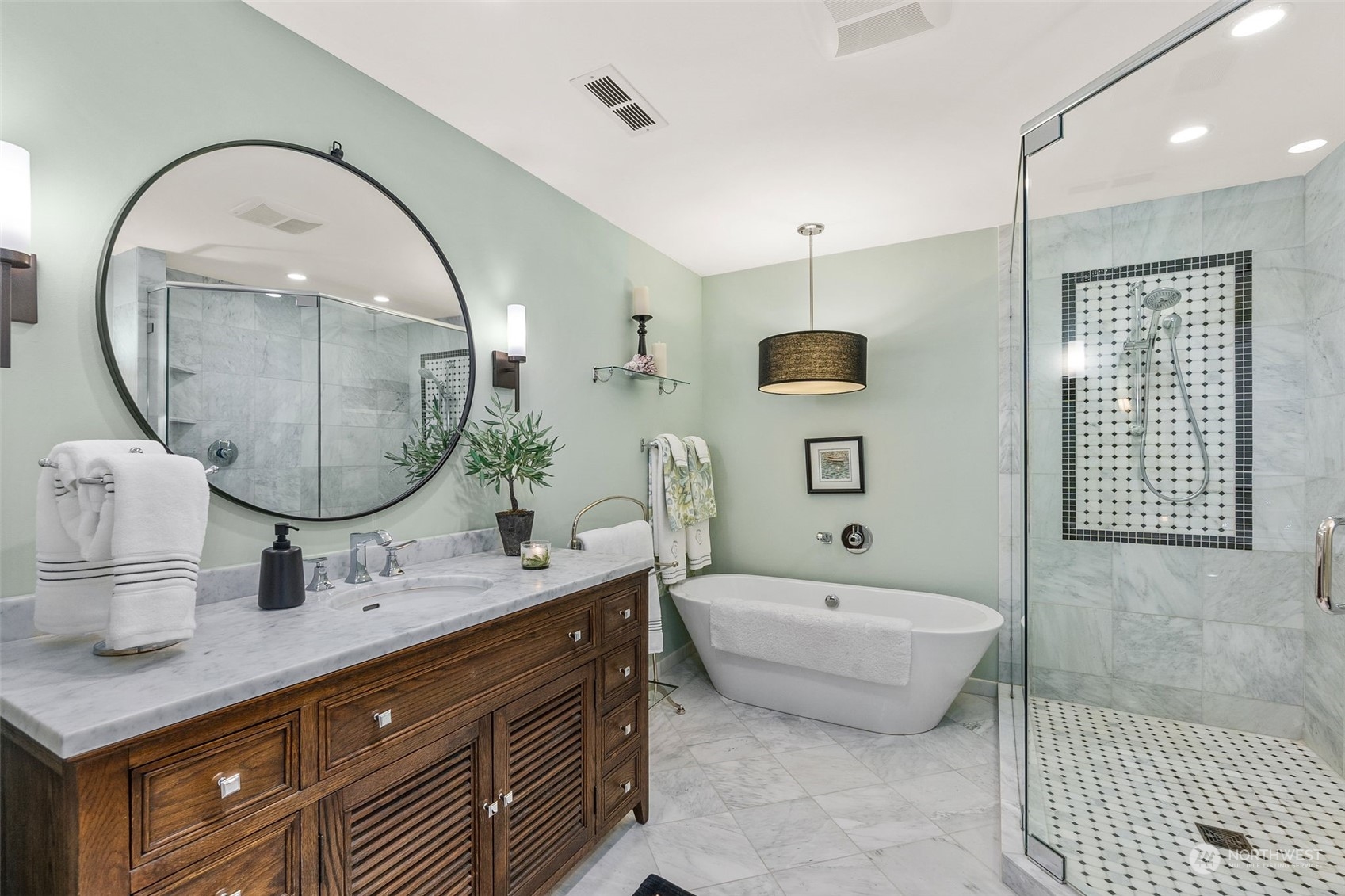 4154 Cooper Point Road Northwest Olympia, WA 98502 - Photo 31 of 40 a spacious bathroom with a sink a mirror and a bathtub
