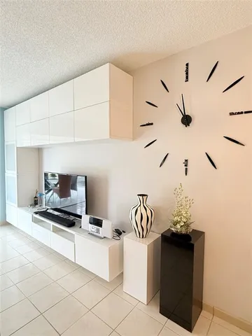 a kitchen with a sink and a stove with white countertops