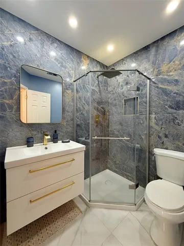 a bathroom with a toilet sink and shower