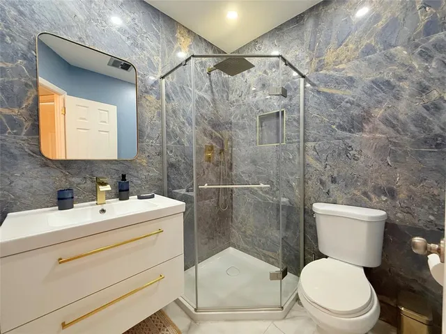 a bathroom with a toilet sink and shower