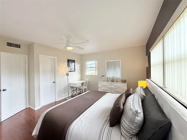 a bedroom with a bed and wooden floor