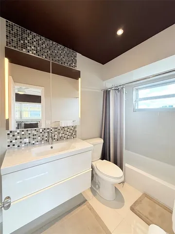 a bathroom with a sink a toilet and a bathtub