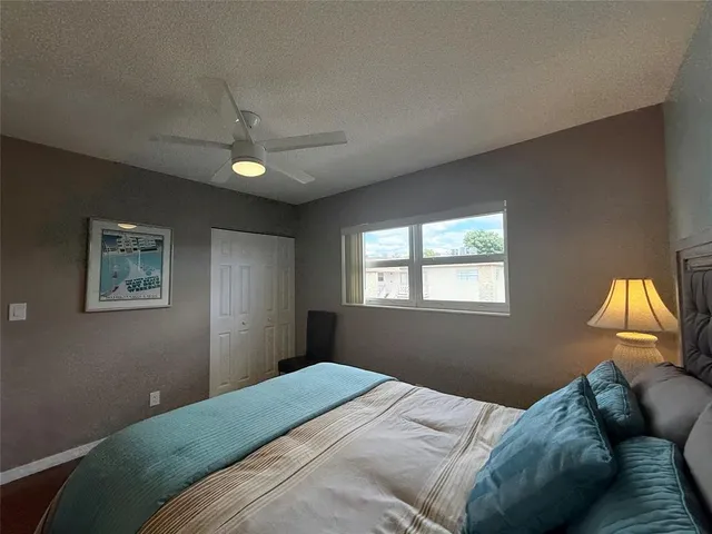 a bedroom with a bed and a lamp