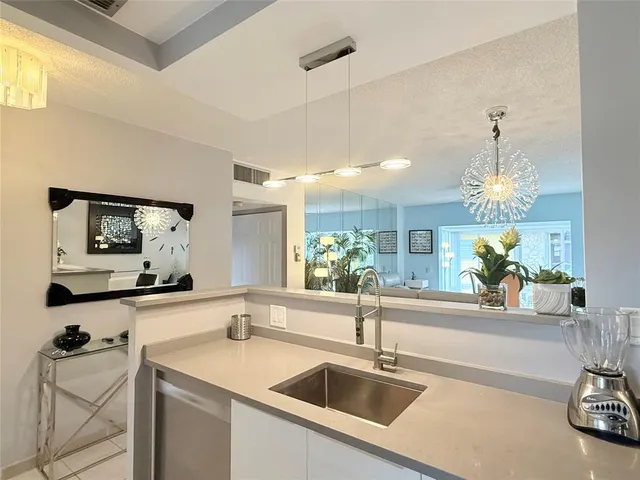 a kitchen with a sink and a refrigerator