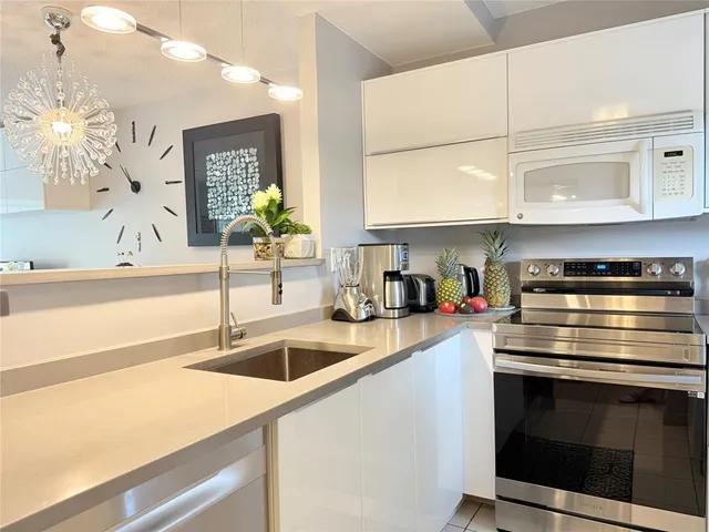 a kitchen with stainless steel appliances granite countertop a sink and a stove