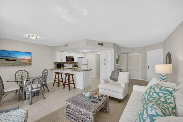 a kitchen with stainless steel appliances kitchen island granite countertop a sink and a refrigerator