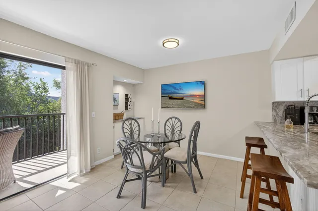 a living room with lots of furniture and view of kitchen