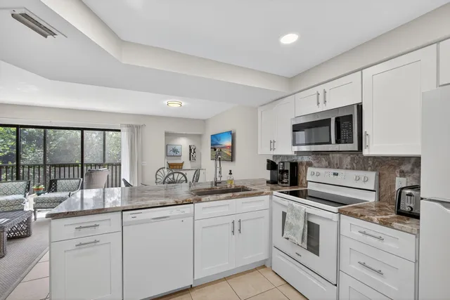 a view of a dining room with furniture and a potted plant