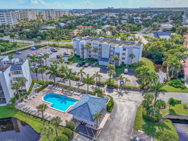 an aerial view of multiple houses with yard