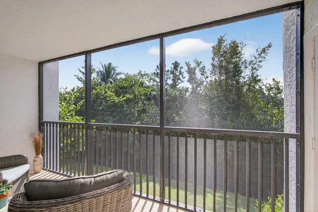 a balcony with furniture and a potted plant