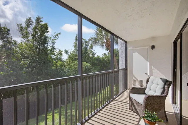 a view of a balcony with wooden floor