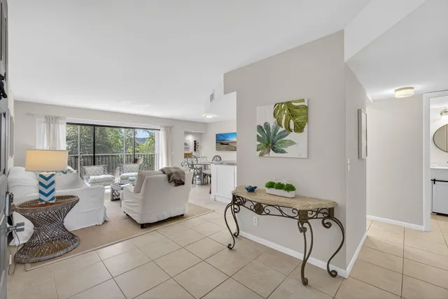 a living room with furniture a flat screen tv and a large window