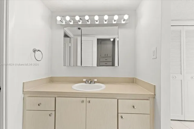 a bathroom with a sink and a mirror