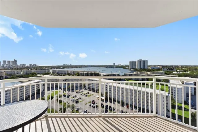 a view of a roof deck with two chairs and wooden floor