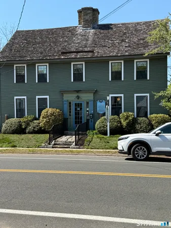a front view of a house with a garden and parking