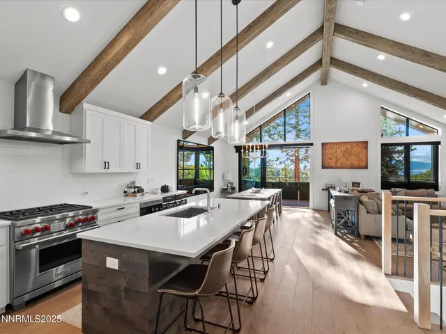 a kitchen with granite countertop a sink cabinets and stainless steel appliances