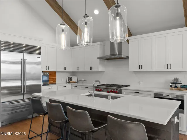 a kitchen with stainless steel appliances a stove a sink and cabinets