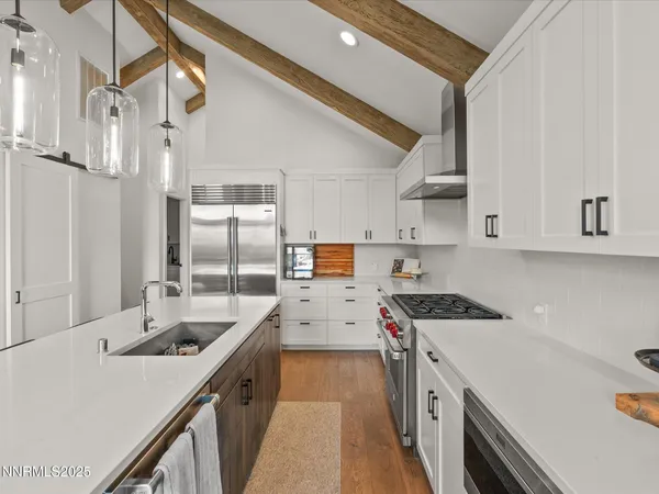 a kitchen with a sink a counter top space and stainless steel appliances