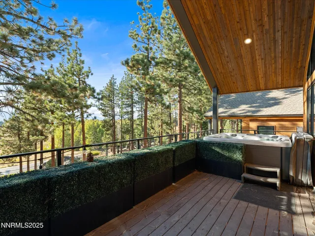 a bedroom with a bed and glass walk in closet