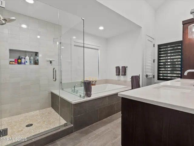 a bedroom with a bed tv and window