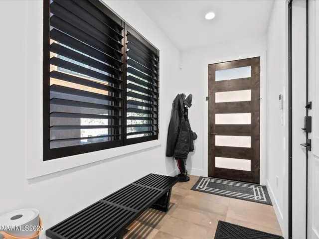 a large white kitchen with lots of counter space dining table and chairs