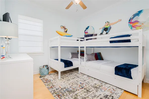 a bed sitting in a bedroom and painting on the wall