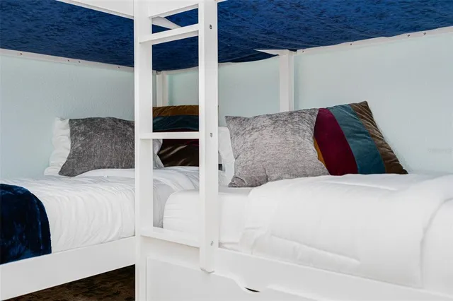 a bedroom with a bed and flat screen tv